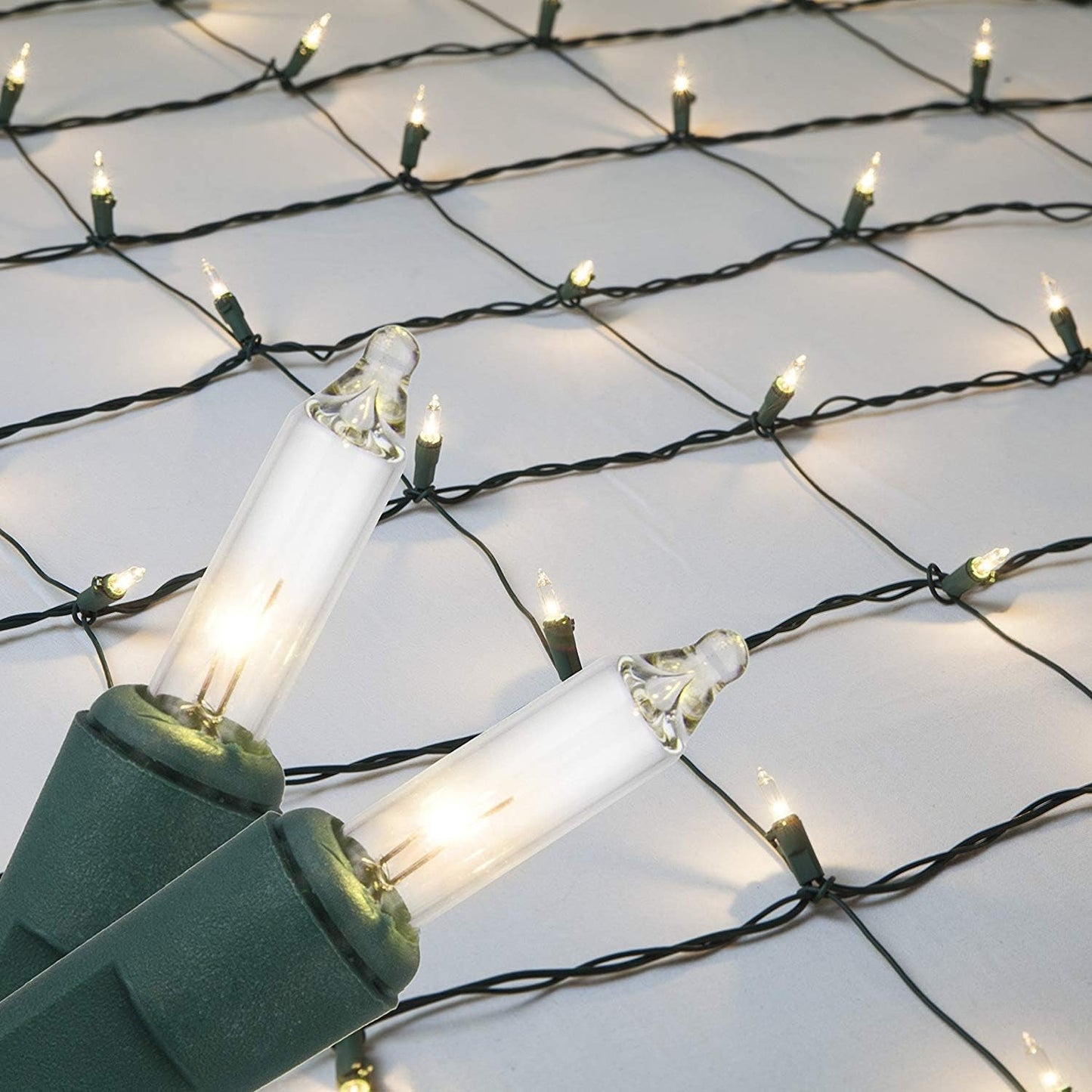 Clear net lights with 150 incandescent bulbs on green wire, ideal for outdoor holiday decorations.