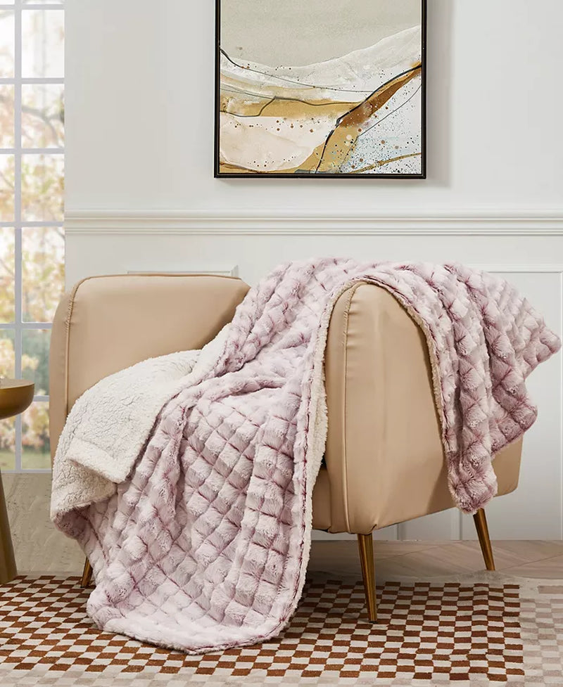 Reversible Micromink to Faux-Sherpa throw blanket draped over a chair, highlighting its cozy, ultra-soft texture.