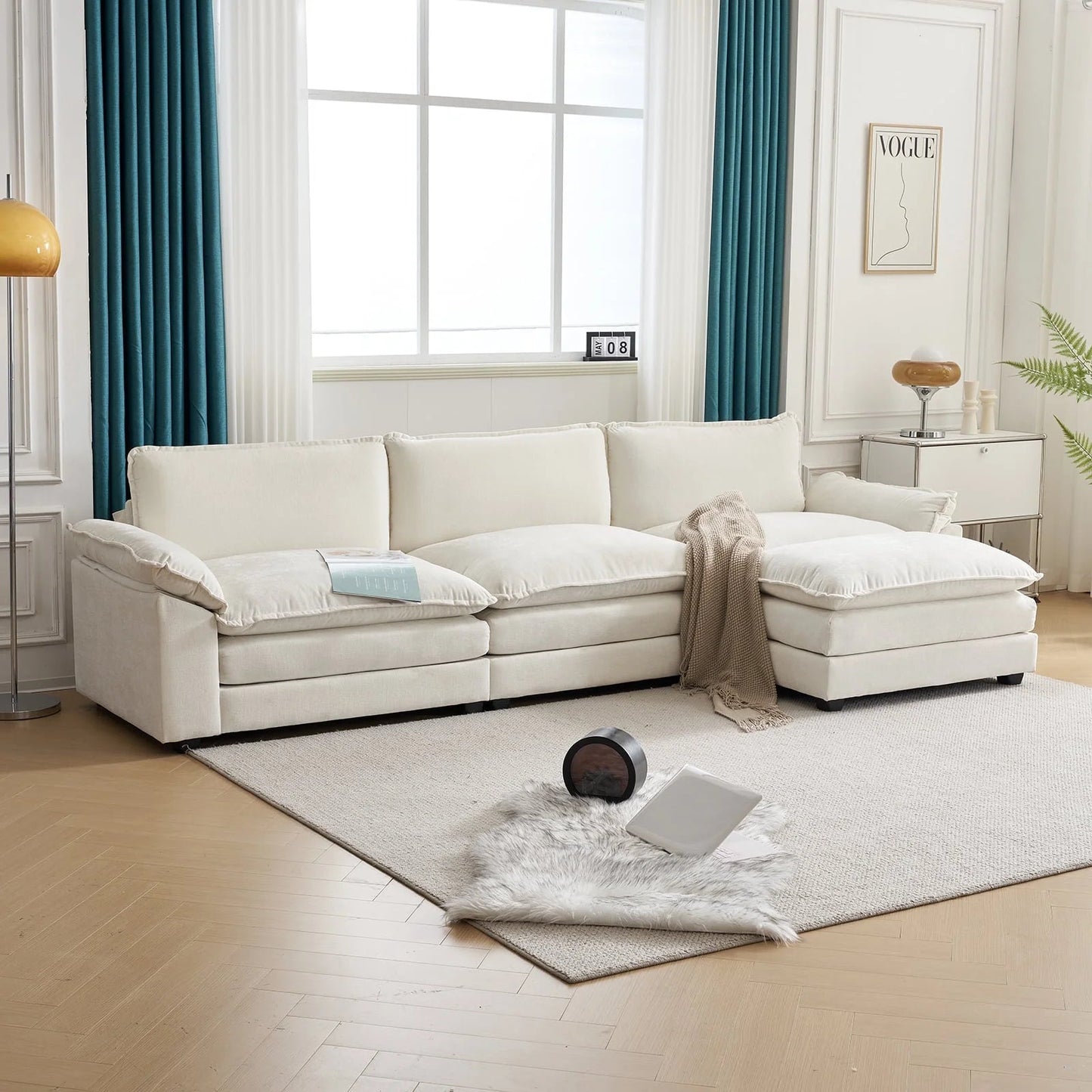 Sectional L-shaped beige sofa with chaise, double layer cushions, and movable footrest in living room setting.