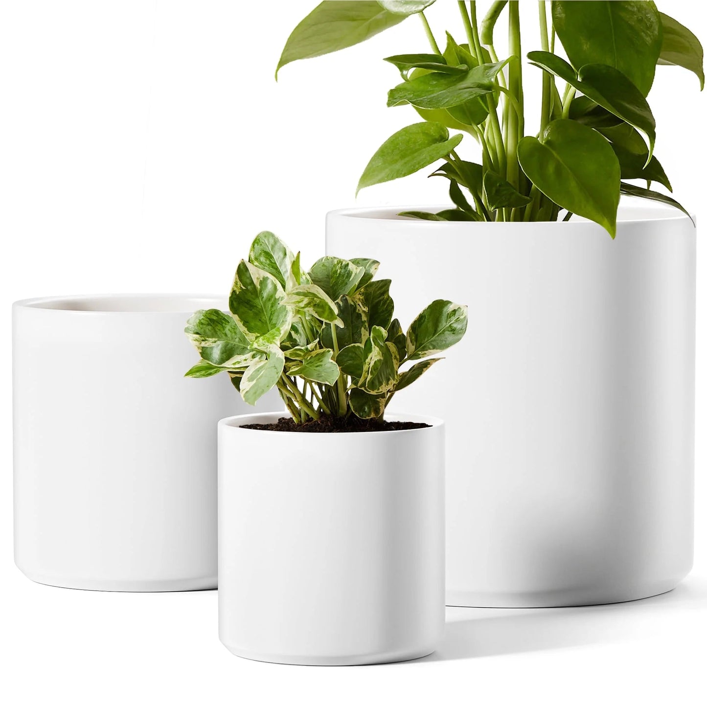 Set of 3 white ceramic plant pots with drainage, suitable for indoor and patio decor.