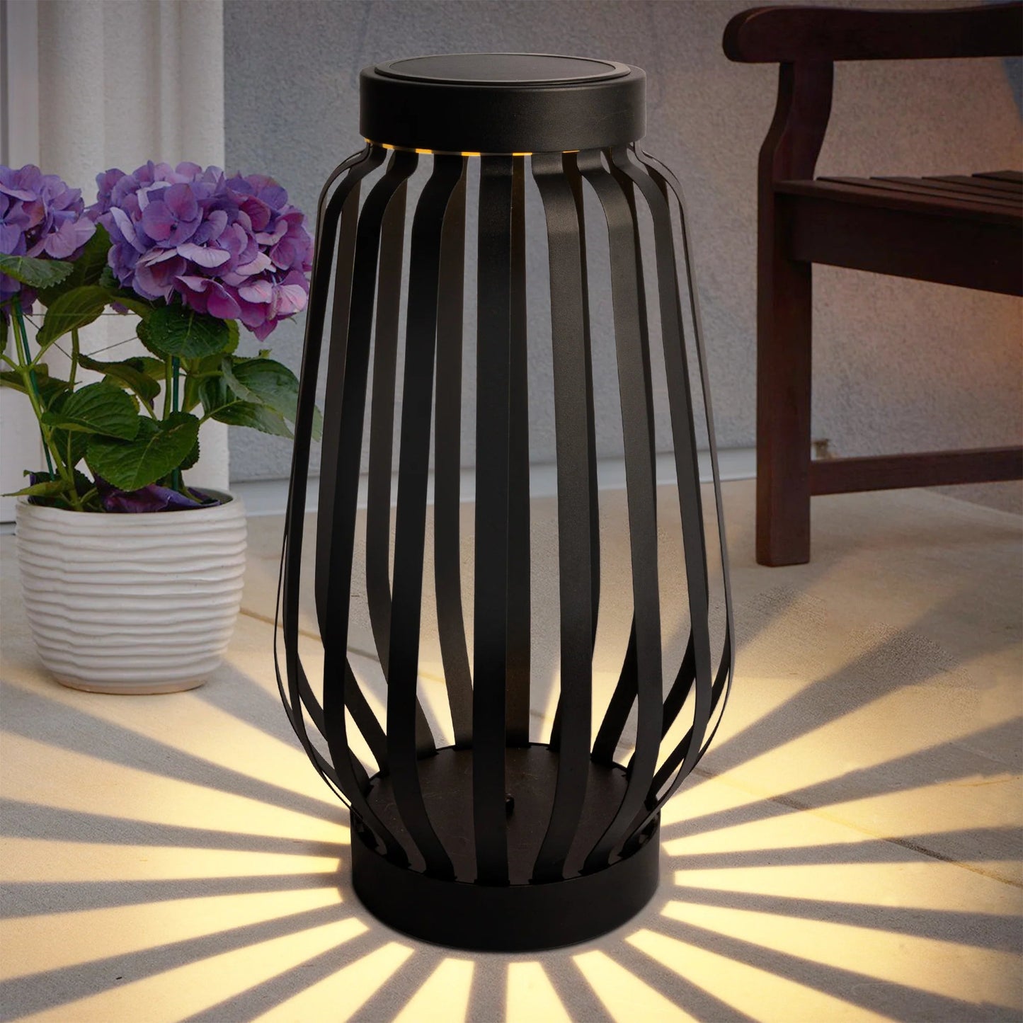 Solar powered outdoor landscaping path light illuminating a patio with sleek modern design.
